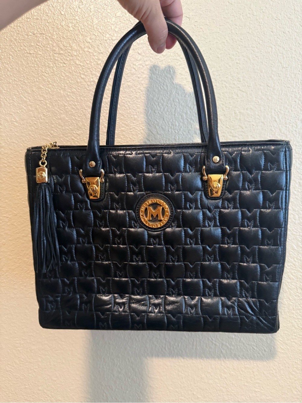 Metrocity Black Quilted Satchel with Gold Emblem and Tassel